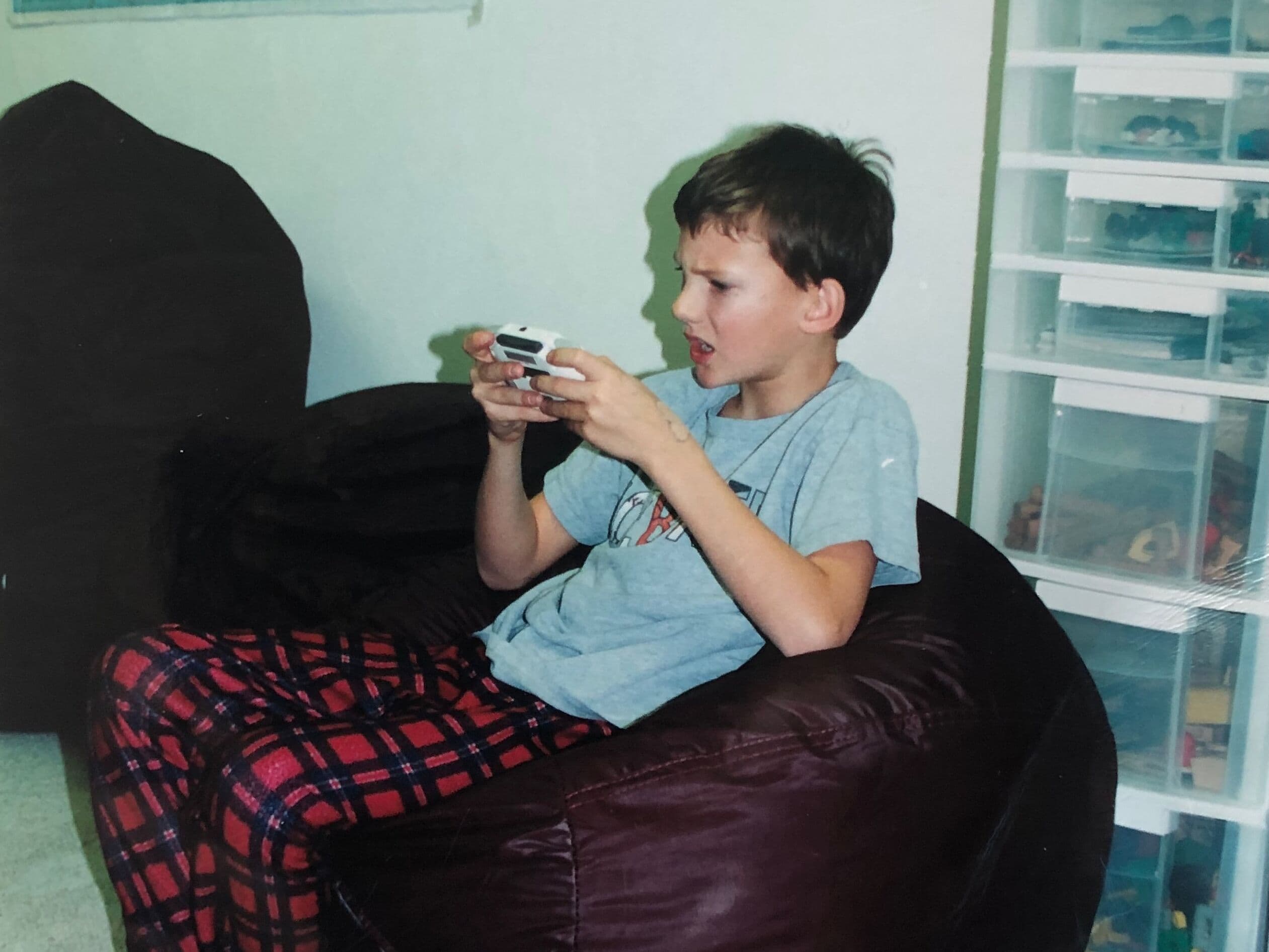 Playing Game Boy, probably Pokemon